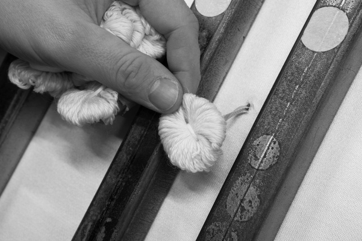 Composed by hand.<br><em>In every mattress we sell.</em>