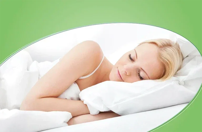 Woman peacefully sleeping on a white cuddle-friendly pillow in a cozy white bed